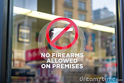No firearms allowed on premises sign on the glass entrance door to establishment notifies patrons that weapons aren`t allowed Stock Photo