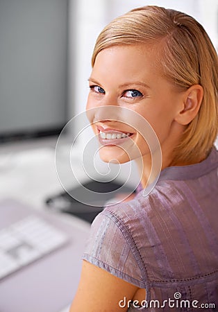 No first day jitters here. Portrait of a beautiful young woman sitting at her desk in an office. Stock Photo