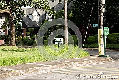 A `No Horn Honking` sign at an intersection Stock Photo