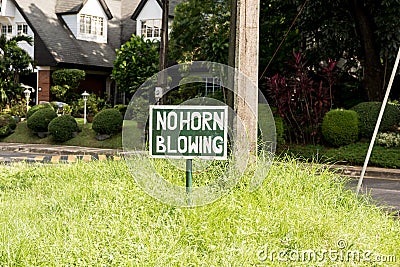 A `No Horn Honking` sign at an intersection Stock Photo