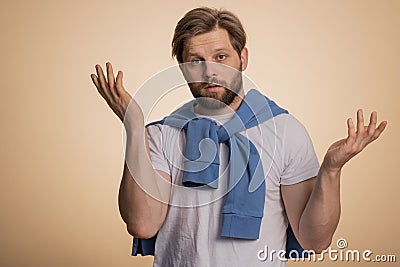 Puzzled clueless uncertain man raising hands in helpless, embarrassed confused by difficult question Stock Photo