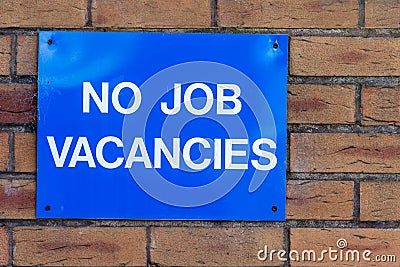 No Jobs Blue Advert Sign On Brick Wall Stock Photo