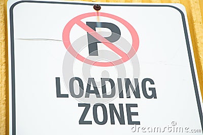 no parking loading zone sign on yellow wall, close up 99 p 20 Stock Photo