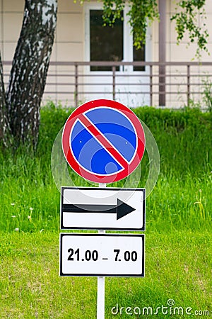 No parking roadsign with direction arrow and time limit Stock Photo