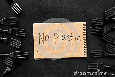 No plastic copy. Eco concept and injunction on the use of plastic flatware on black background top view Stock Photo