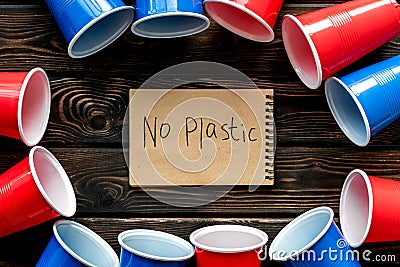 No plastic copy. Eco concept and injunction on the use of plastic flatware on wooden background top view Stock Photo