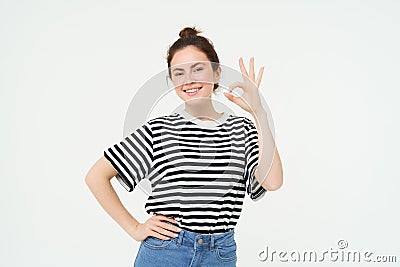 No problem, excellent choice. Smiling, confident young woman, showing okay, ok sign, zero gesture, recommends product Stock Photo