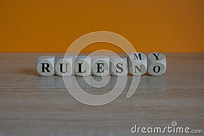 No rules to my rules symbol. Turned dice and changes the expression no rules to my rules. Beautiful orange background. Business Stock Photo