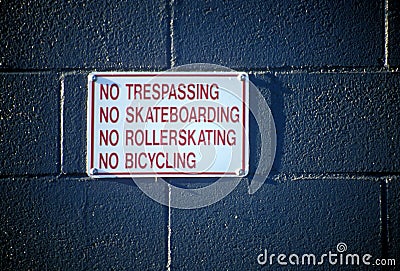 No Sign No Trespassing on a Brick Wall Stock Photo