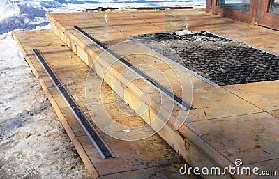 No Slip Treads for House Entrance Stairs. Stair Exterior with melting snow and ice. House slippery stair Stock Photo