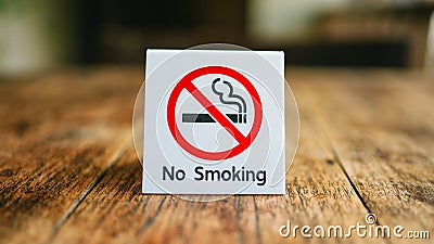 No Smoking label in the public. No smoking sign on wood table at hotel Stock Photo