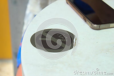 No smoking sign on outdoor table with mobile phone Stock Photo