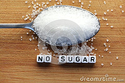 No sugar phrase made from plastic letter cubes placed in a spoon full of sugar Stock Photo