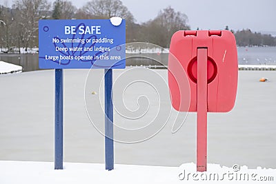 No swimming or paddling deep water danger sign and red buoy ring life save Stock Photo