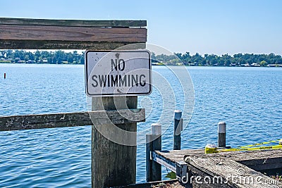 No Swimming Warning on a Dock in Louisiana, USA Stock Photo