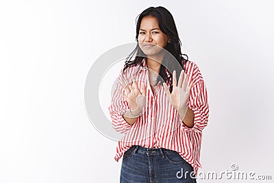 No thanks I fine. Portrait of awkward woman saying sorry refusing offer, waving palms near chest reluctant, smirking and Stock Photo