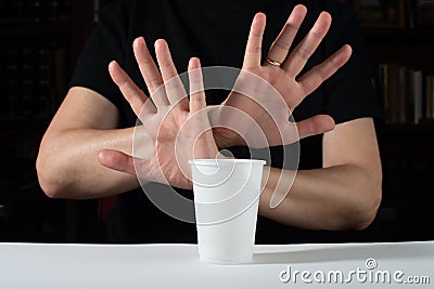 No to disposable plastic. Hand gesture rejects single-use plastic cup Stock Photo