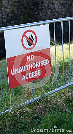 No Unauthorised Access Sign on a metal fence Stock Photo