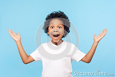 No way, I can`t believe! Portrait of funny amazed preschool boy keeping hands up in astonishment Stock Photo