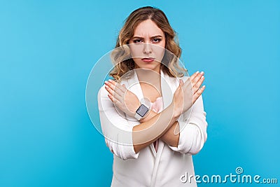 No way, never again. Portrait of determined serious woman crossing hands on chest, gesturing x sign. blue background Stock Photo