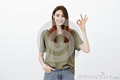 No worries, everything is okay. Portrait of confident calm attractive woman in dark-green t-shirt, holding hand in Stock Photo