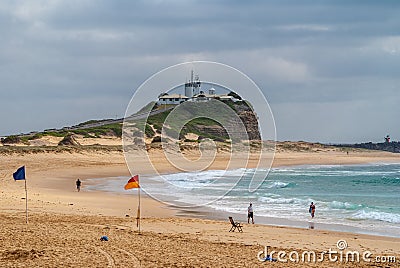 Nobbys lighthouse in distance on its hill at ocean in Newcastle, Australia Editorial Stock Photo