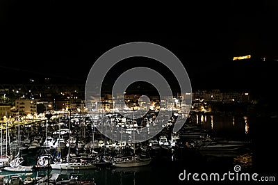 Nocturnal Elegance of Porto Ercole: Moonlit Tranquility on Argentario's Shores Stock Photo