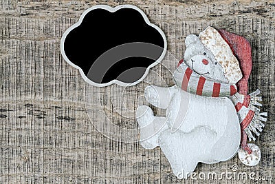 Noel background with carved bear and blank chalkboard on wood table Stock Photo