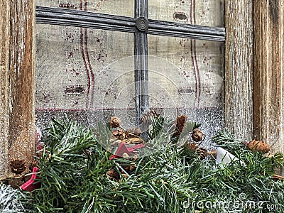 Noel decoration with pine tree branches in front of a window Stock Photo