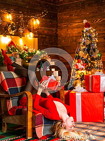 Noel. Girl enjoy cozy atmosphere christmas eve. Pleasant moments. Woman wooden interior christmas decorations garland Stock Photo