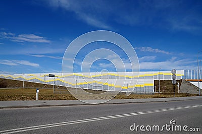 A noise-absorbing barrier also called a soundwall, noise wall, Stock Photo