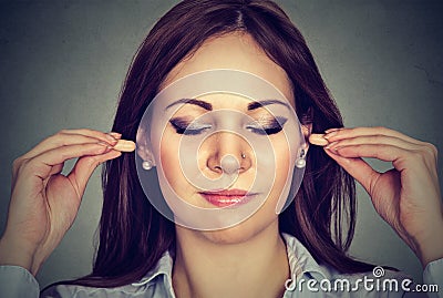 Noise control. Young woman with ear plugs Stock Photo