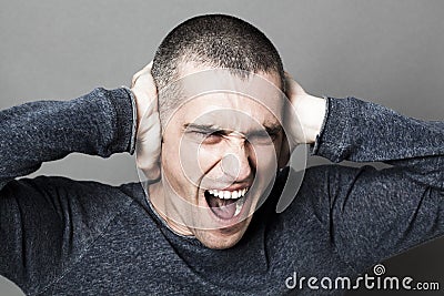 Noise and hearing concept for enraged young man screaming Stock Photo