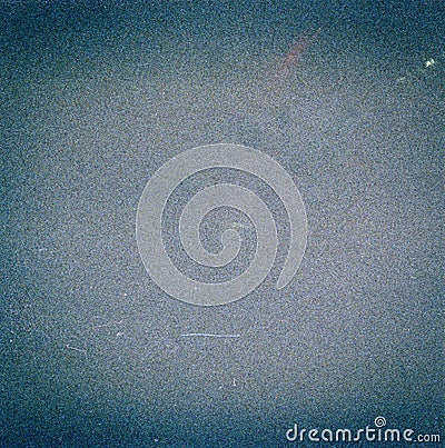 Noisy blue film frame with scratches, dust and grain. Stock Photo