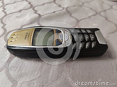 Nokia old Mobile Phone in black and gold colors, Nokia`s most popular phone launched in the 2000`s Editorial Stock Photo