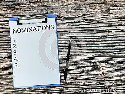 Nominations and listing numbers written on paper clipboard with a pen. Stock Photo
