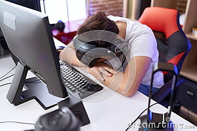 Non binary man streamer stressed using computer at gaming room Stock Photo