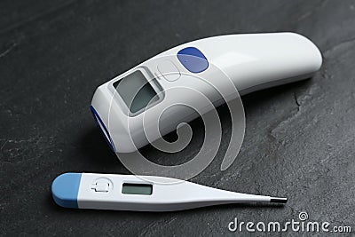 Non-contact infrared and digital thermometers on slate background Stock Photo