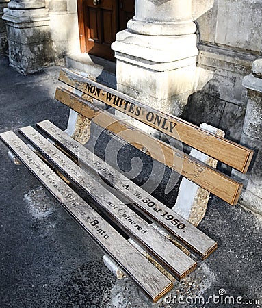 Non whites only - old bench with an inscription left as memory of apartheid, racism and segregation Stock Photo