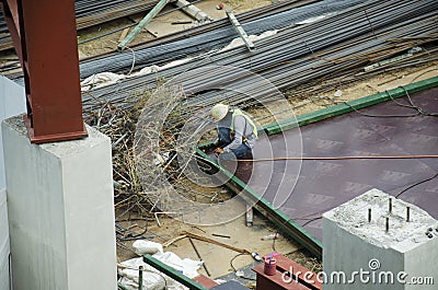 Thai people worker weld steel in construction site making reinforcement metal framework for concrete pouring in Bangkok, Thailand Editorial Stock Photo