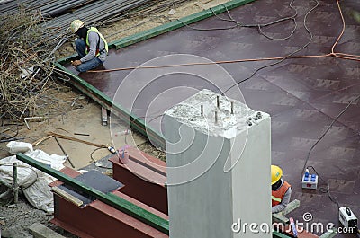 Thai people worker weld steel in construction site making reinforcement metal framework for concrete pouring in Bangkok, Thailand Editorial Stock Photo