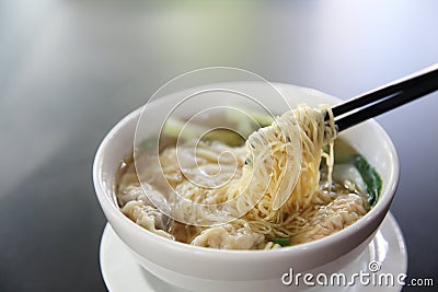 Noodle and wonton soup on a bowl Stock Photo