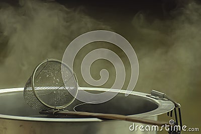 Noodle strainer with wood handle and warm aluminum stock pot Stock Photo