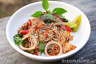 noodles plate with instant noodles stir fried with vegetables herb spicy tasty appetizing asian noodles mix seafood stir fried Stock Photo