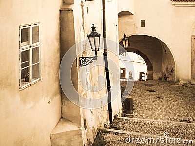 Nooks of Lesser Town in Prague. Old staircase with street lamp and tunnel. Vintage sepia style image. Prague, Czech Stock Photo