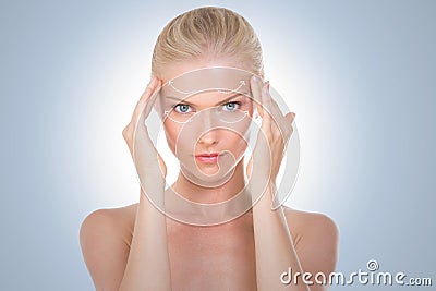 Nordic beauty massaging her temples Stock Photo