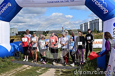 Nordic walking athletes of different ages and genders begin the competition at the start walking in a group Editorial Stock Photo