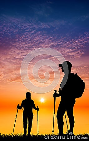 Nordic walking silhouette at sunset Stock Photo