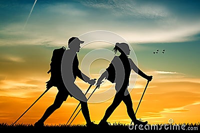 Nordic walking at sunset Stock Photo