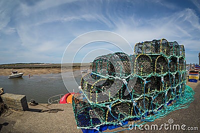 Norfolk coastline, fishing baskets and blue skies Stock Photo